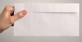 Person holding envelope