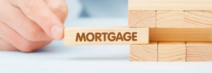 Jenga game with 'mortgage' block