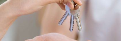 Handing over a set of house keys, freehold and leasehold