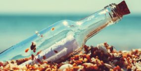 Message in a glass bottle on the beach