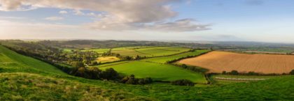 Morning light illuminates the landscape of the Somerset Levels viewed from Corton Beacon hill in South Somerset, England