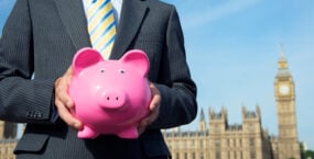 spring-budget-british-politician-holding-classic-pink-piggy