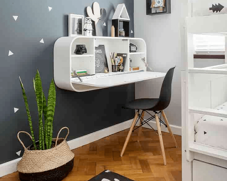 Fold down white desk in a small home office 