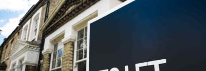 Estate agency 'To Let' sign board on street of British houses