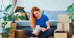 Worried young woman looking through apartment rent agreement