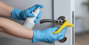 Cleaning door handles with an antiseptic during a viral epidemic