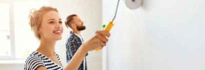 couple-repairing-painting-wall-what-not-to-fix-before-selling
