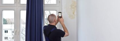 man-taking-photo-big-patch-mould-or-damp3