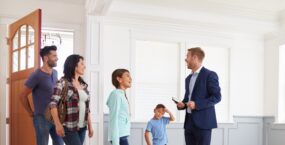 choosing-an-estate-agent-showing-family-around-new-house