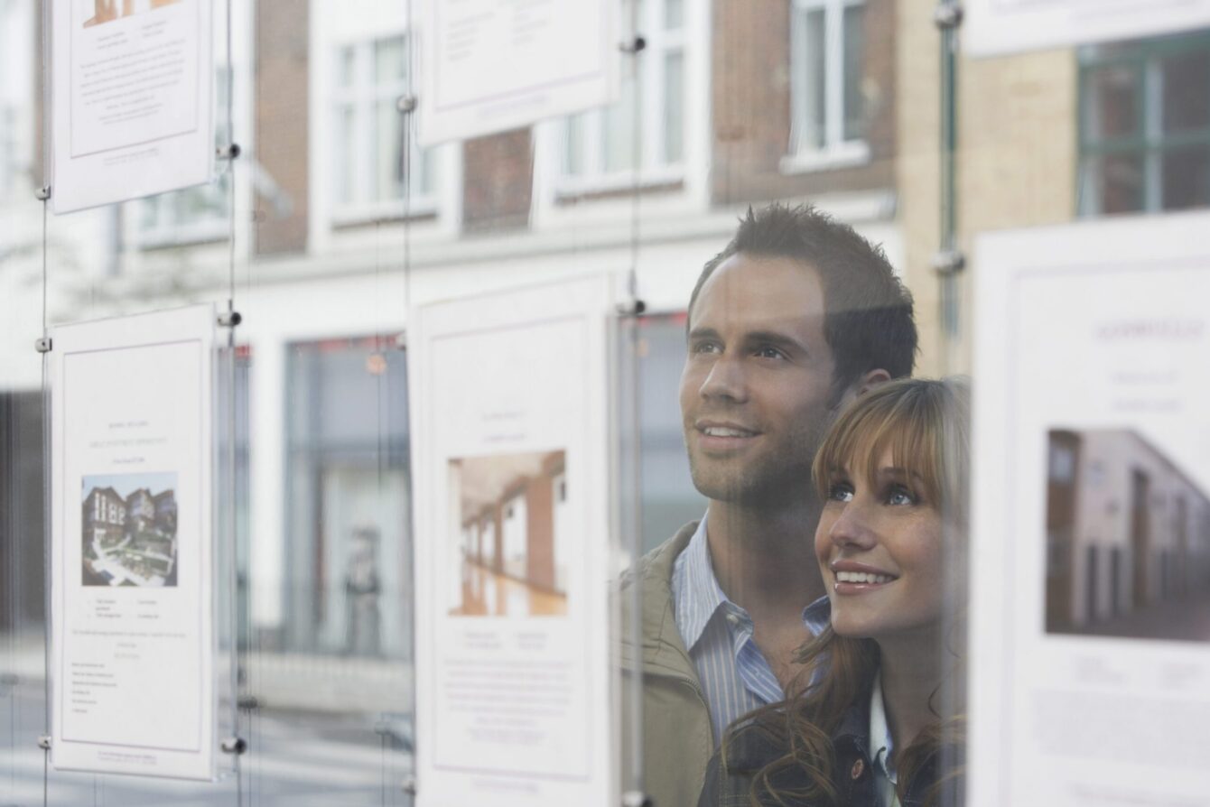 buying-your-first-home-young-couple-window-shopping