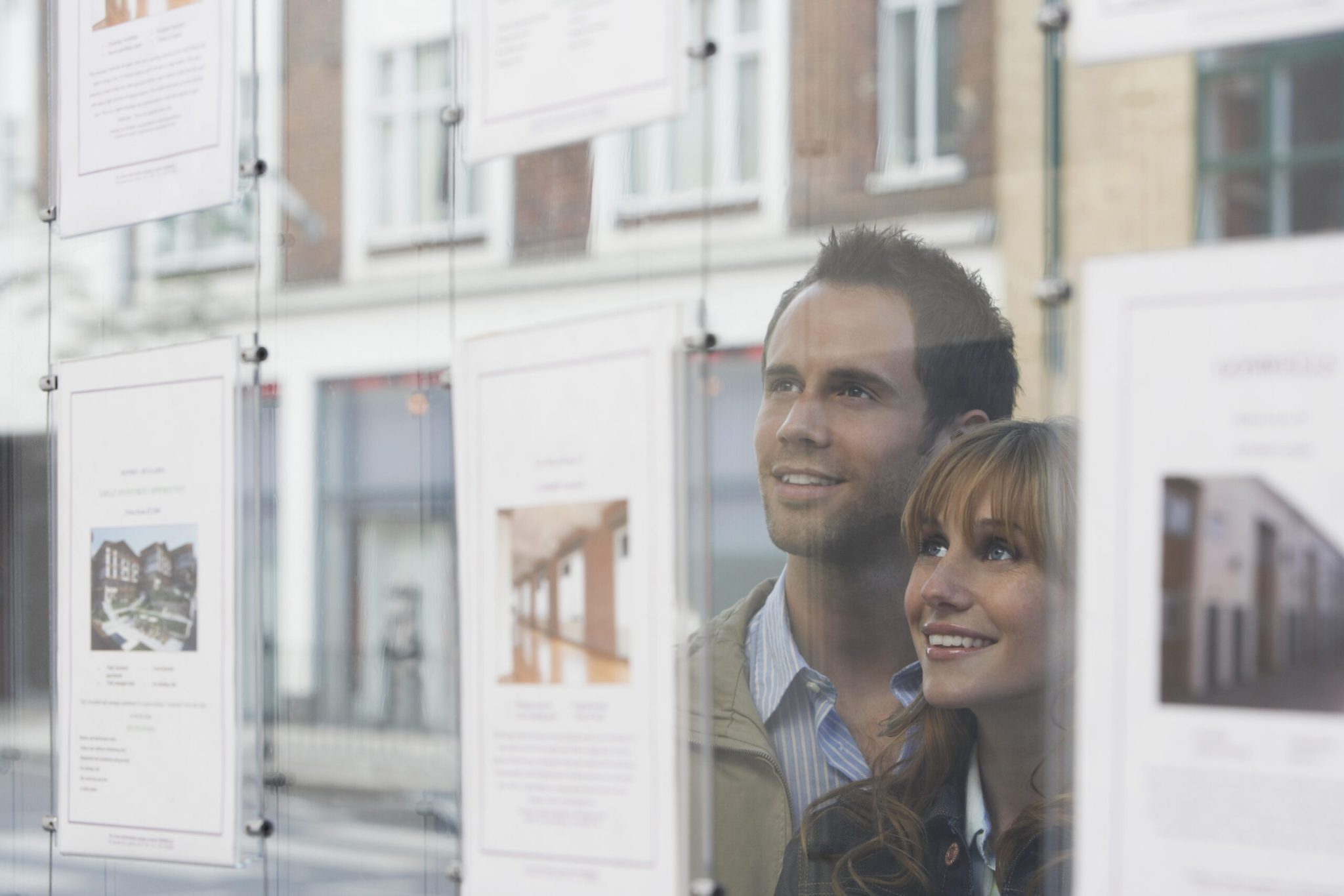 buying-your-first-home-young-couple-window-shopping